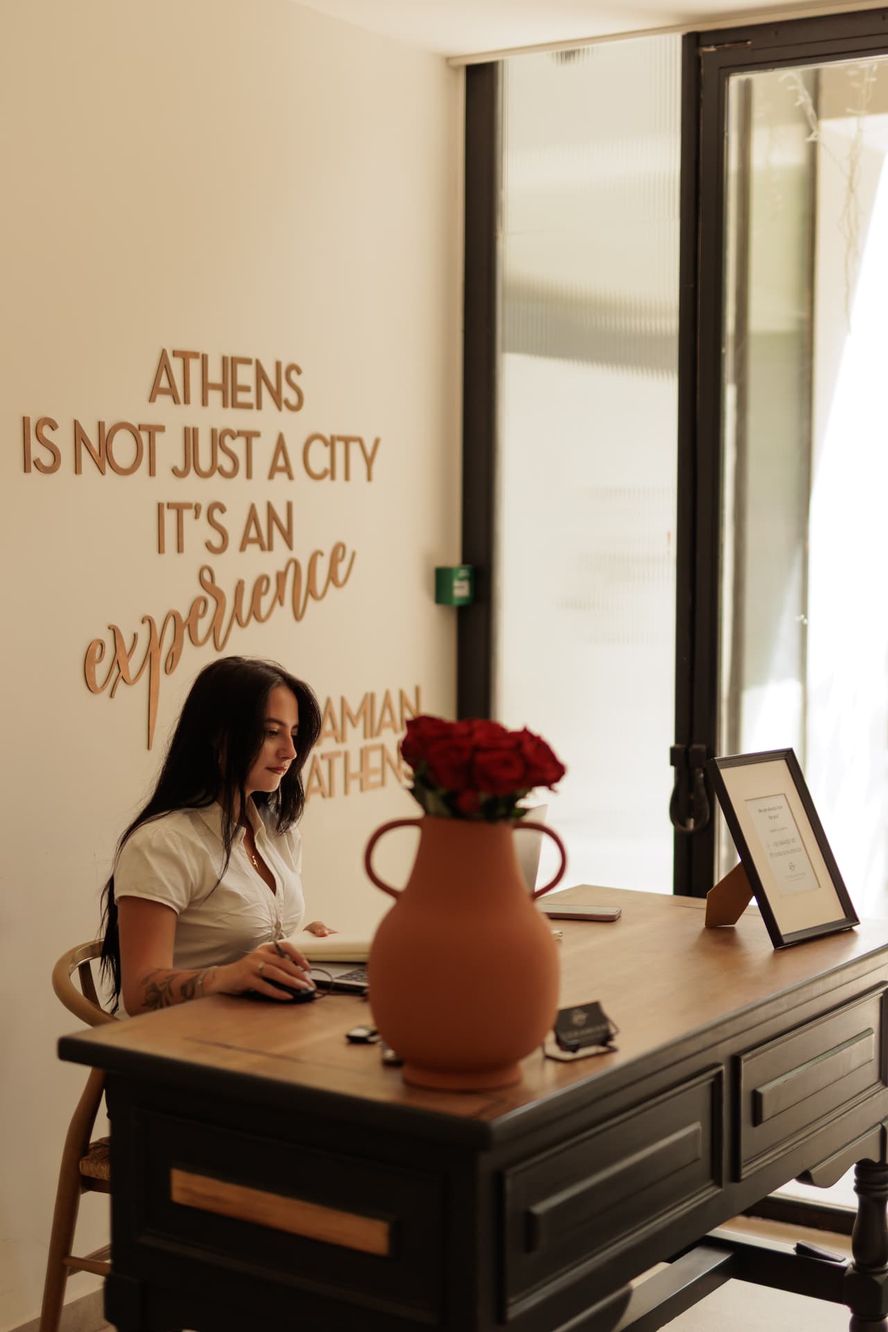 Ceramian Athens concierge at the front desk planning a guest's stay