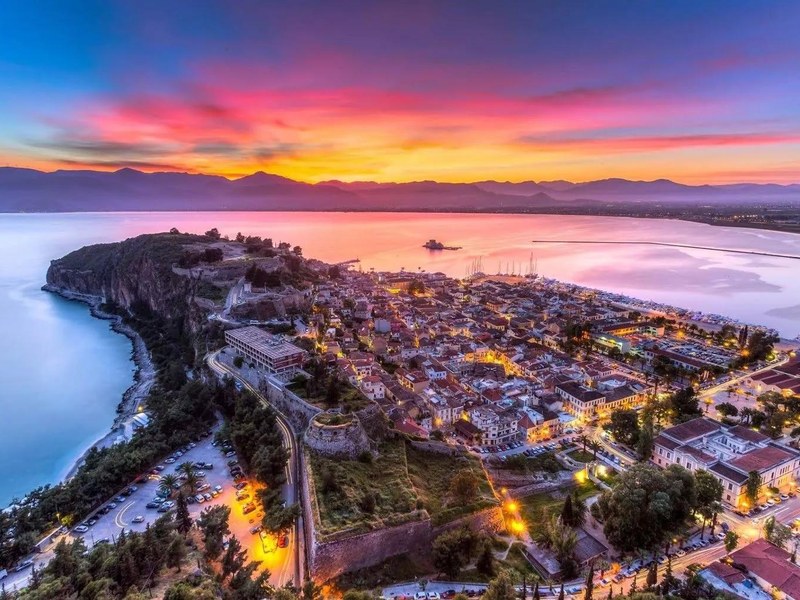 Aerial sunset view of Nafplio's harbour, old town rooftops and Venetian fortress